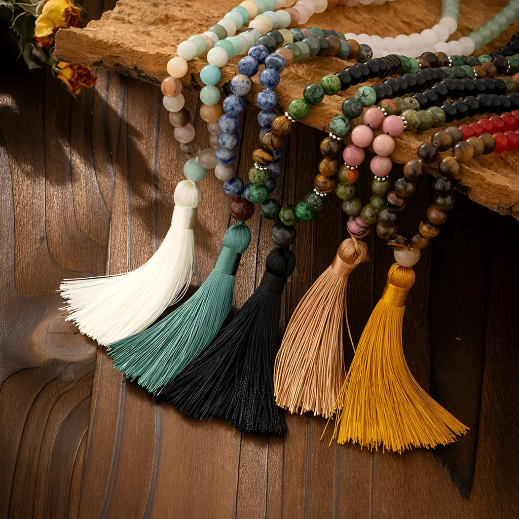 Vintage bohemian style long necklace with natural stone beads, geometric chain, tassel, and matching bracelet on a grey background.