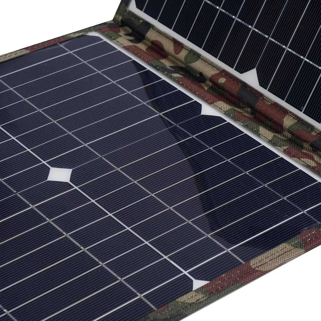 Black foldable portable solar panel unfolded showing three solar cell sections, with battery clips and car charger accessories