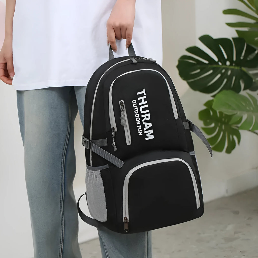 Large dark blue outdoor backpack with an air pillow belt, shown folded and unfolded.