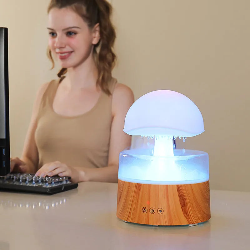 White cloud-shaped humidifier with falling raindrops and colour-changing night light