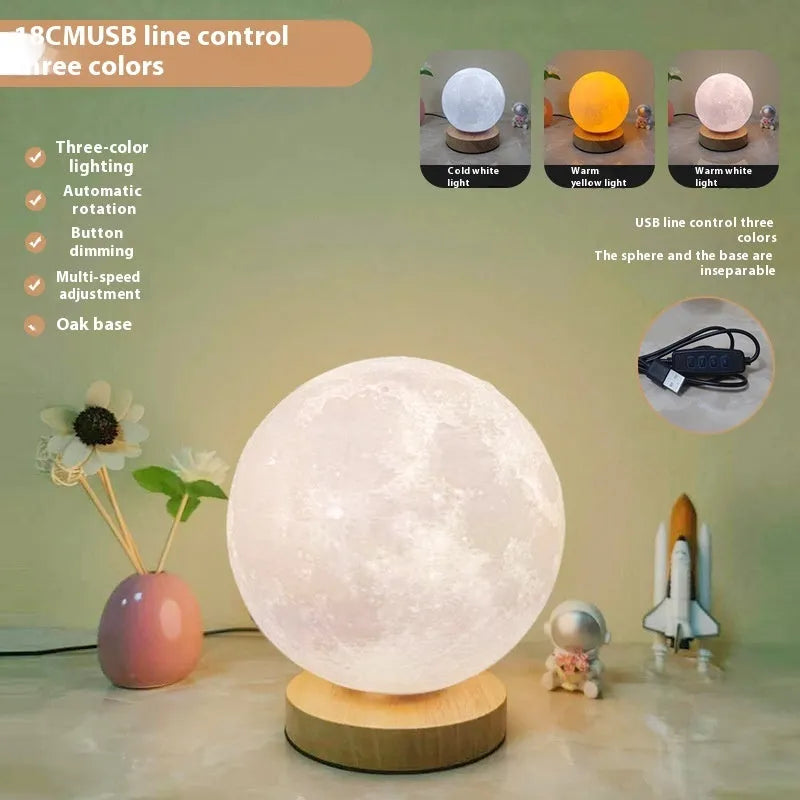 Rotating moon night lamp with wooden base on a table, showing three colour settings and remote control.