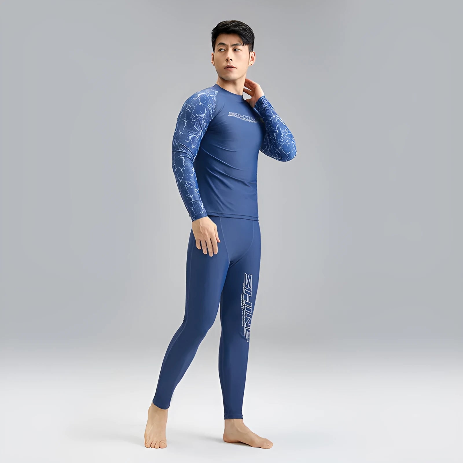 Dark blue men's two-piece swimwear set with a top and trousers on a mannequin.