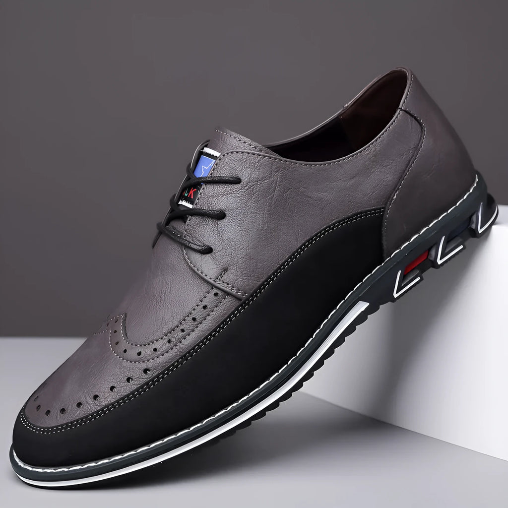 Men's black leather-toe casual shoes with fabric upper and rubber sole on a plain background.