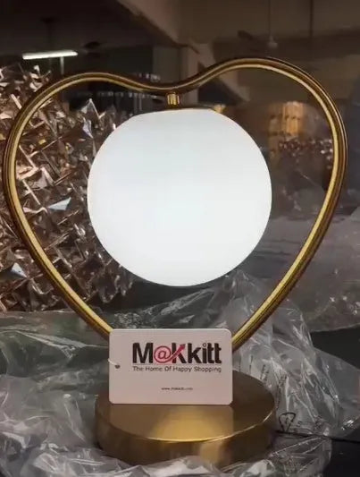Heart shaped white decorative LED lamp with warm lighting on tabletop