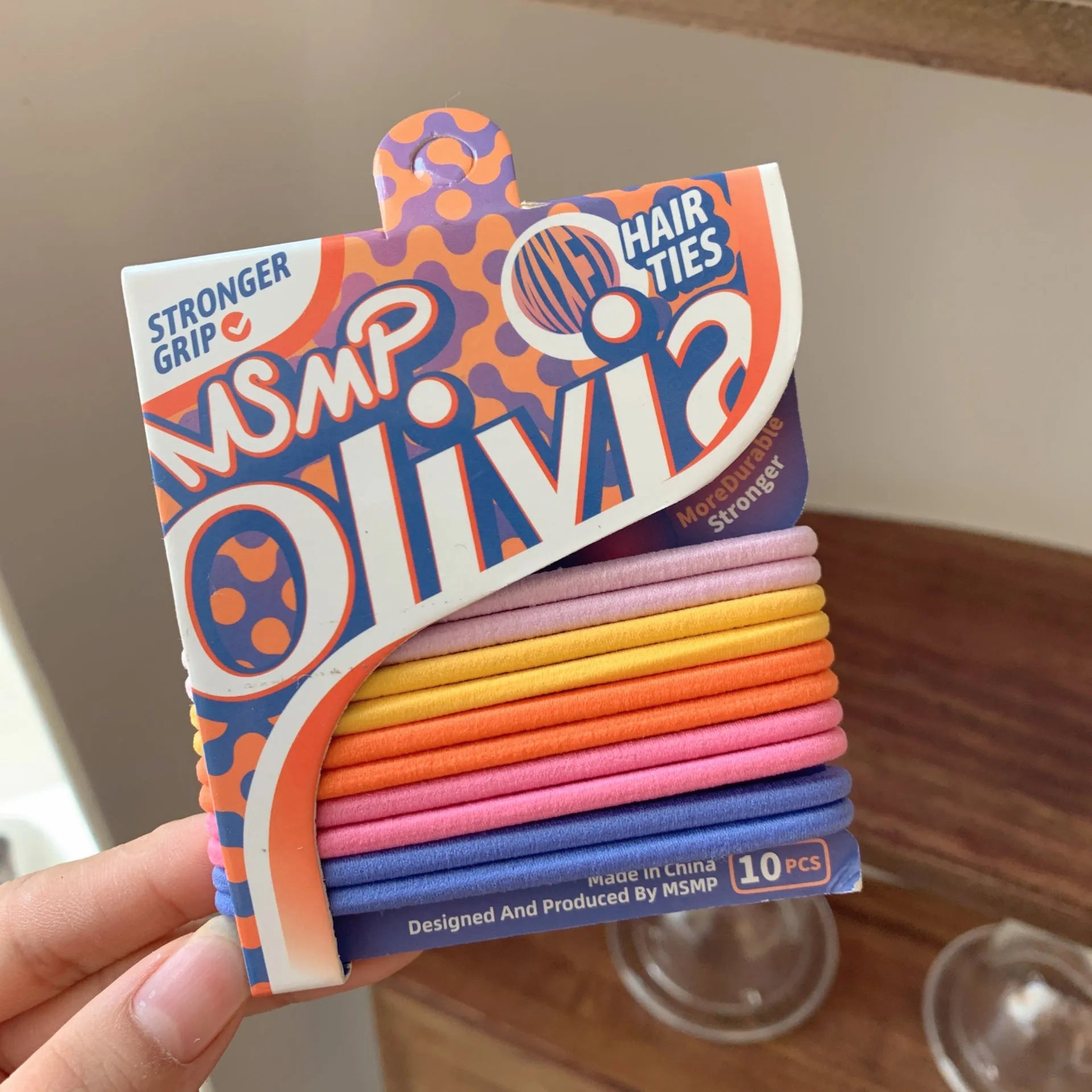 Assorted candy colour braided elastic hair bands laid flat, showing no metal parts.