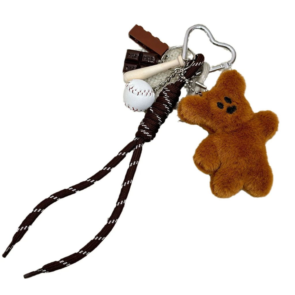 Soft plush brown bear doll pendant keychain hanging on a bag, with a cute bear/piglet animal pattern
