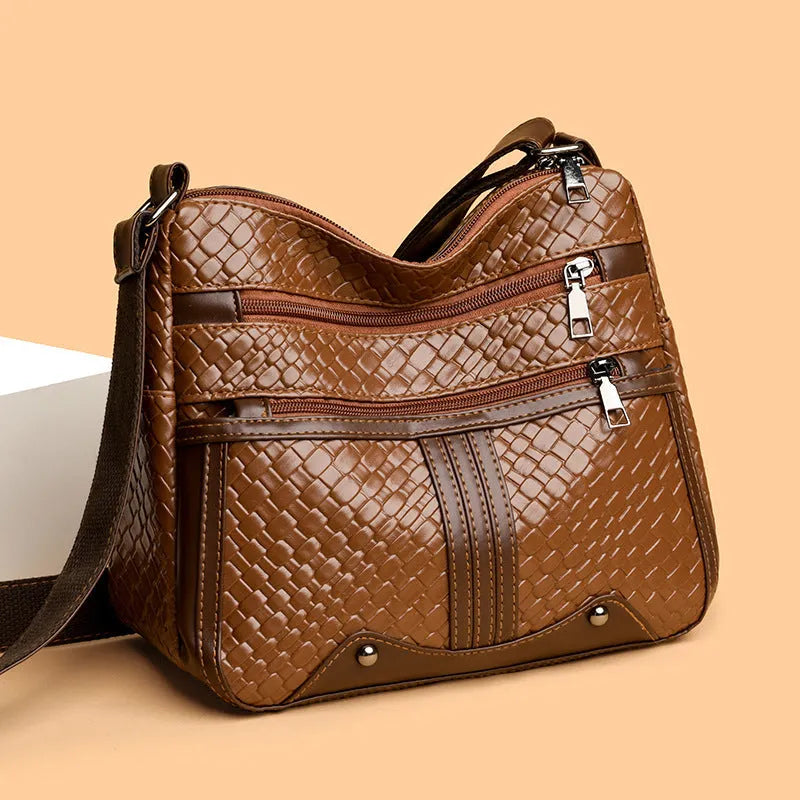Brown woven PU messenger bag with single shoulder strap, showing multi-compartment interior with zippered change purse