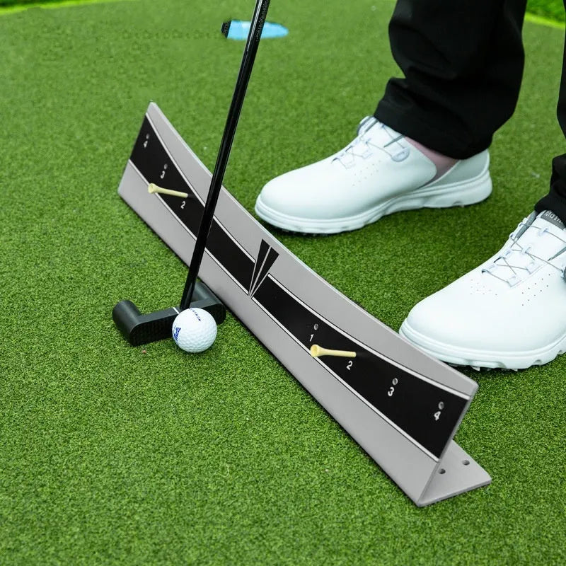 Adjustable golf putter trajectory balance simulator made from white PVC on a green mat.