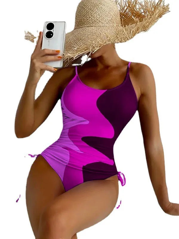 Women's blue one-piece swimsuit with sleeveless backless design and printed stripe pattern