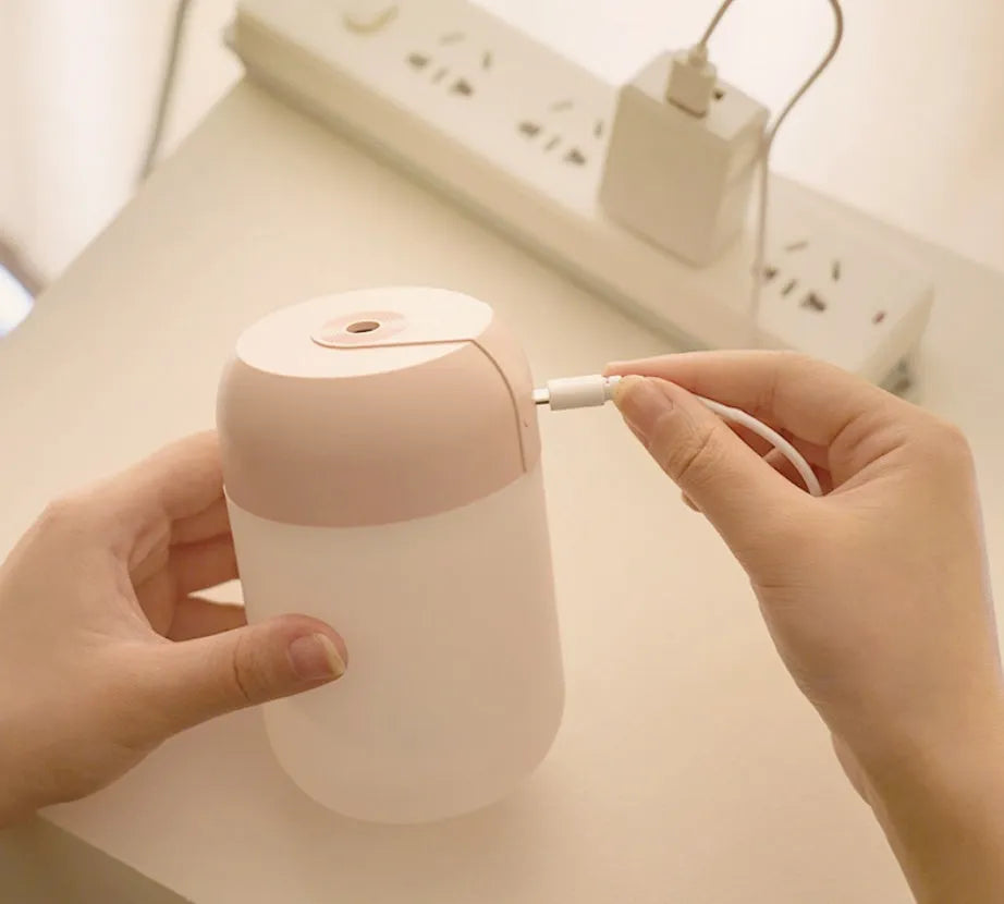 Small white cylindrical USB-powered humidifier for silent bedroom and desk use.