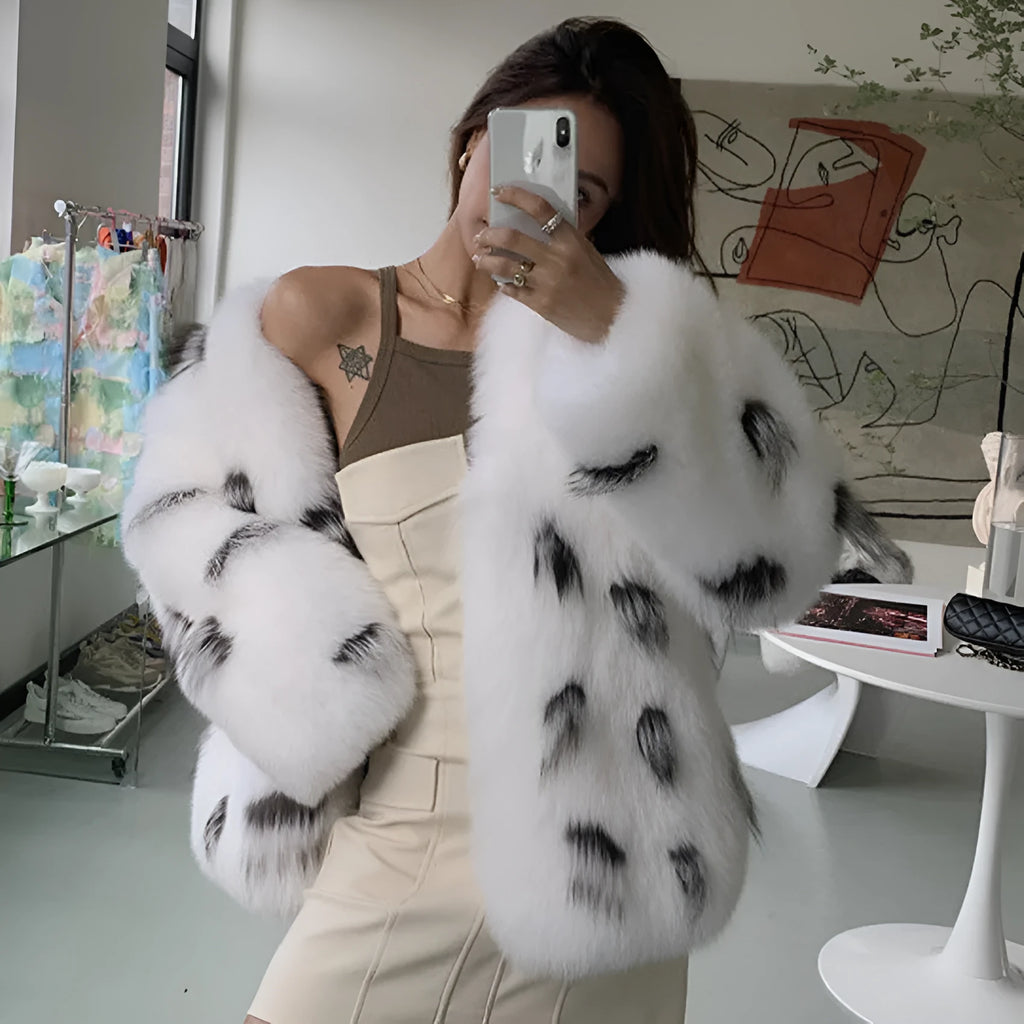 Black and white faux fur raccoon coat on a model, showing short length and slim Korean-style fit.