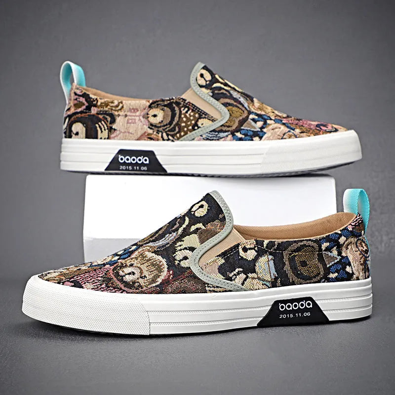 A pair of low-top canvas slip-on sneakers with a round toe and vulcanised rubber sole on a neutral background.