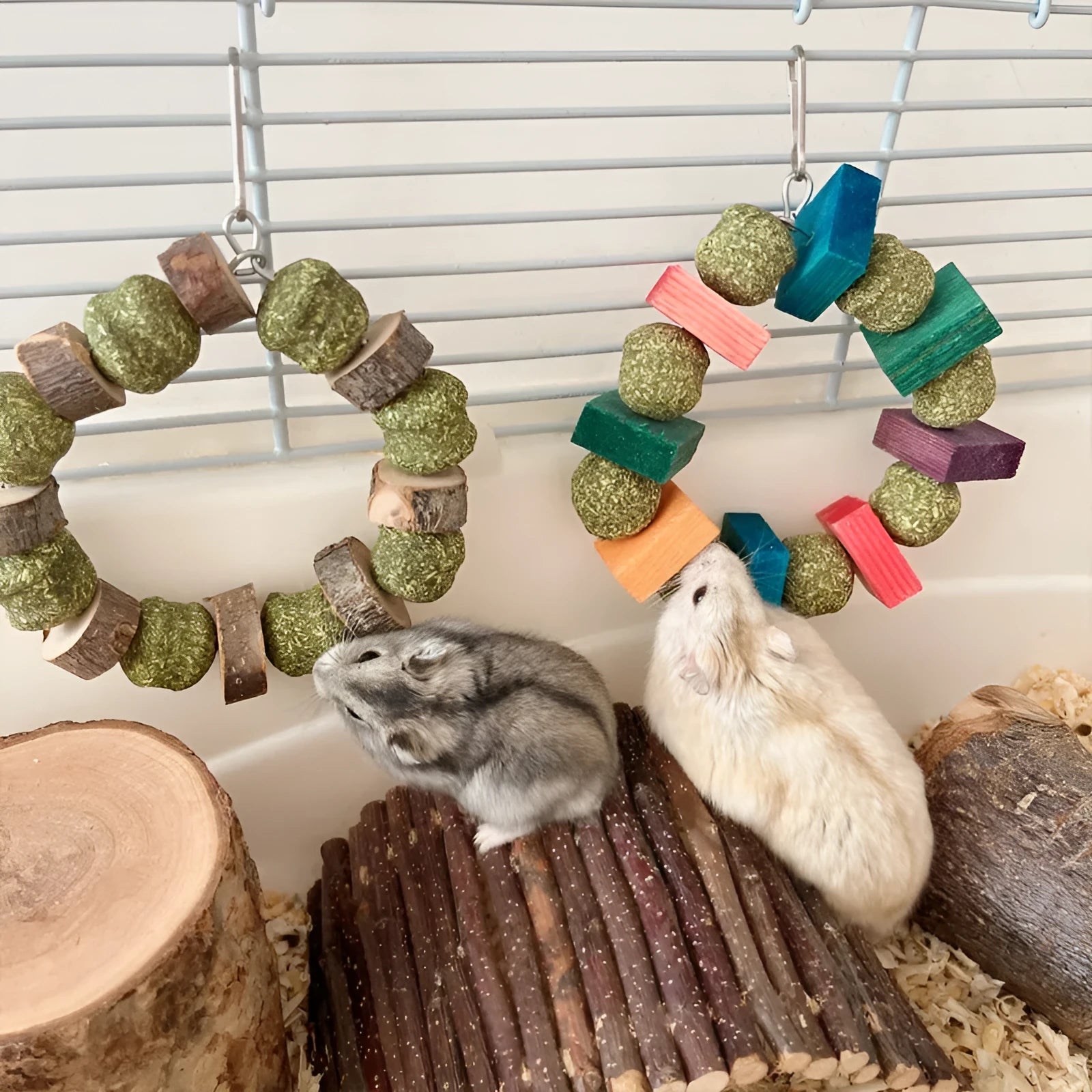 Hamster chew toy with two straw ball rings - one colourful sequin design, one natural applewood