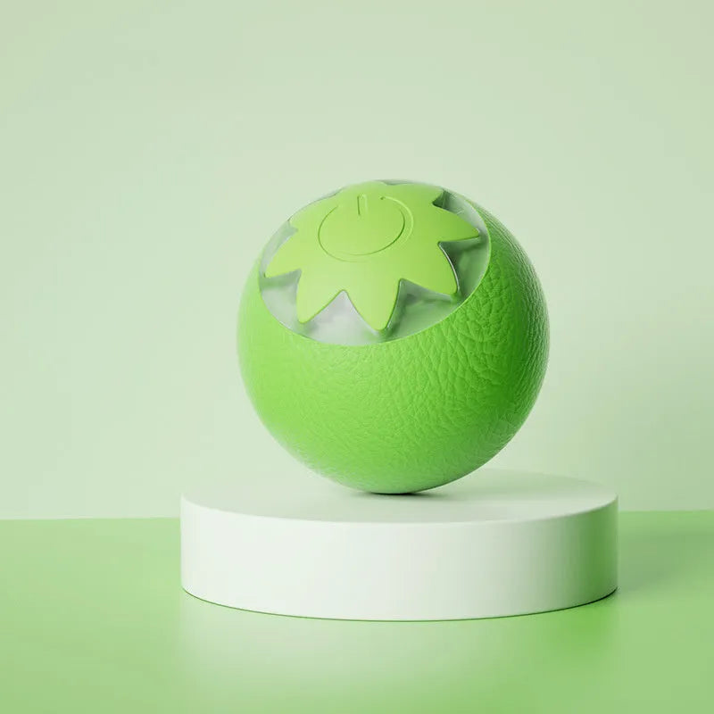 Green rolling ball electric pet toy for dogs and cats on indoor floor surface