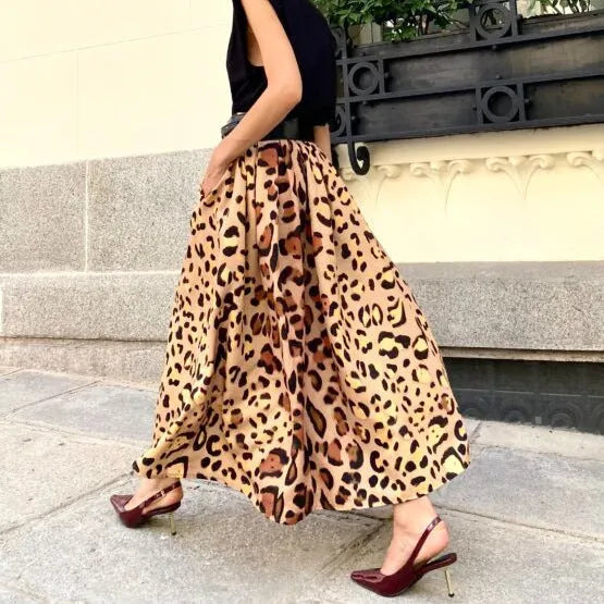 Brown leopard print women's A-line long skirt with a large hem, shown on a hanger.
