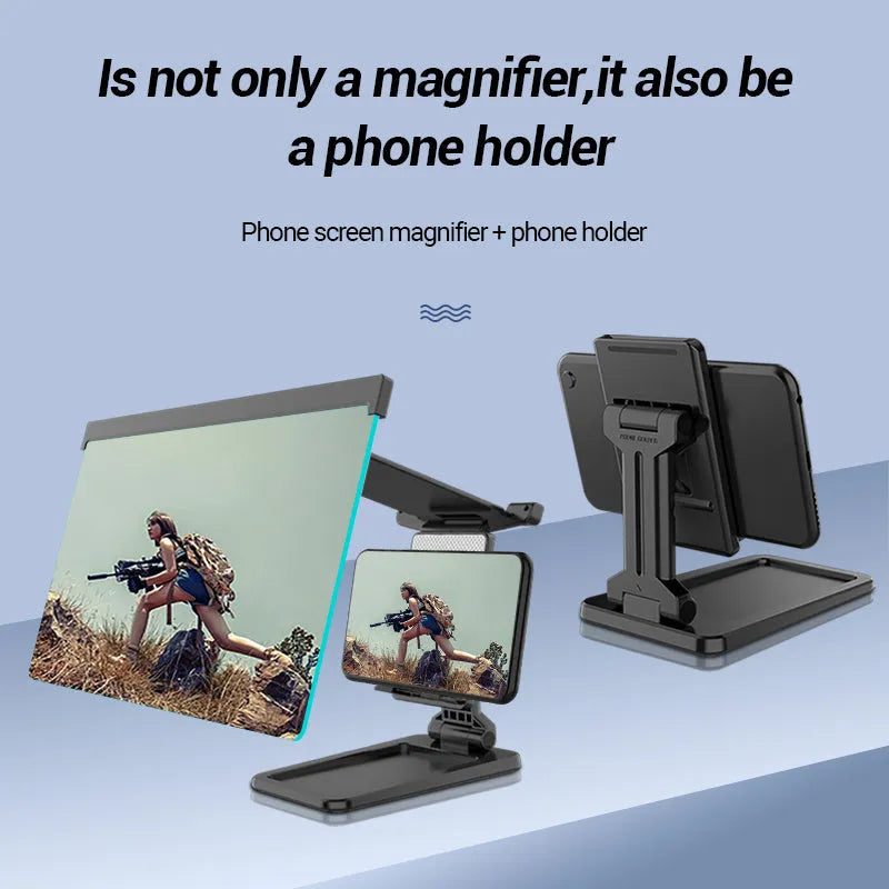 Black foldable mobile phone screen amplifier with a detachable phone holder on a desktop.