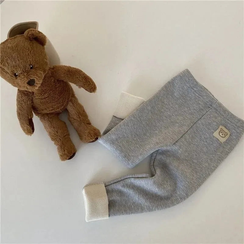 Girls' high-waist fleece-lined leggings in beige, shown with elastic hairband belt detail.