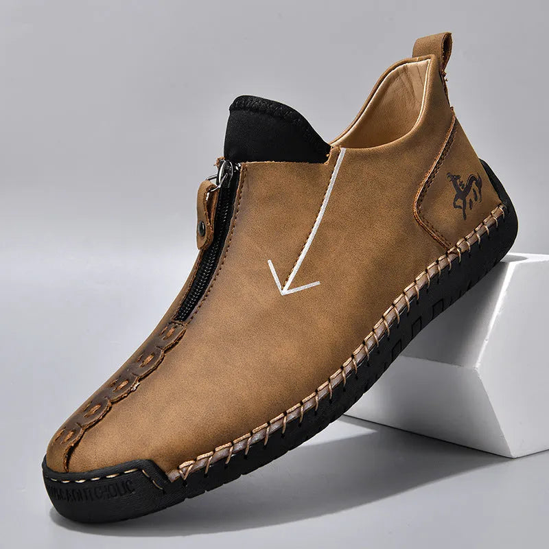 Men's black leather zip-up martin boots with round toe and low heel on a rubber sole.