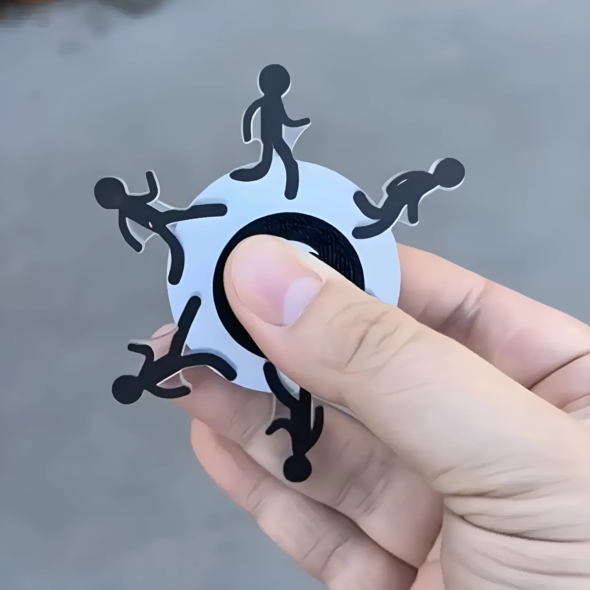 Acrylic stickman running fingertip gyro on finger showing spinning motion
