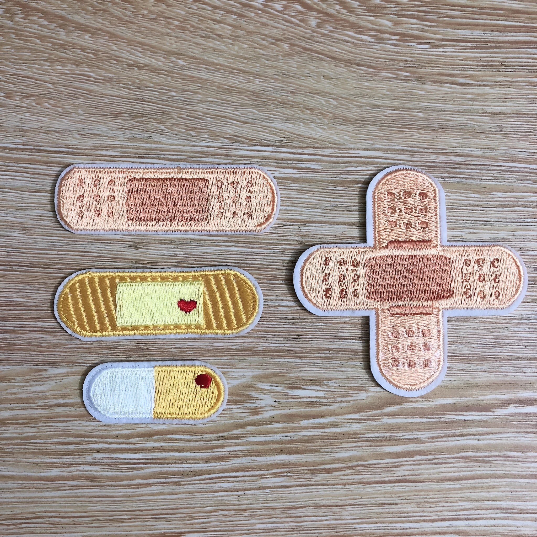 Ten colourful embroidered fabric patches with adhesive backing for clothing decoration