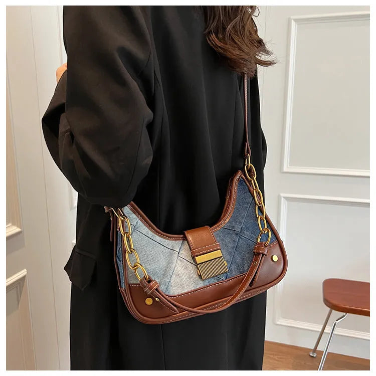 Brown denim women's bucket shoulder bag with diamond mesh detail and chain strap connector.