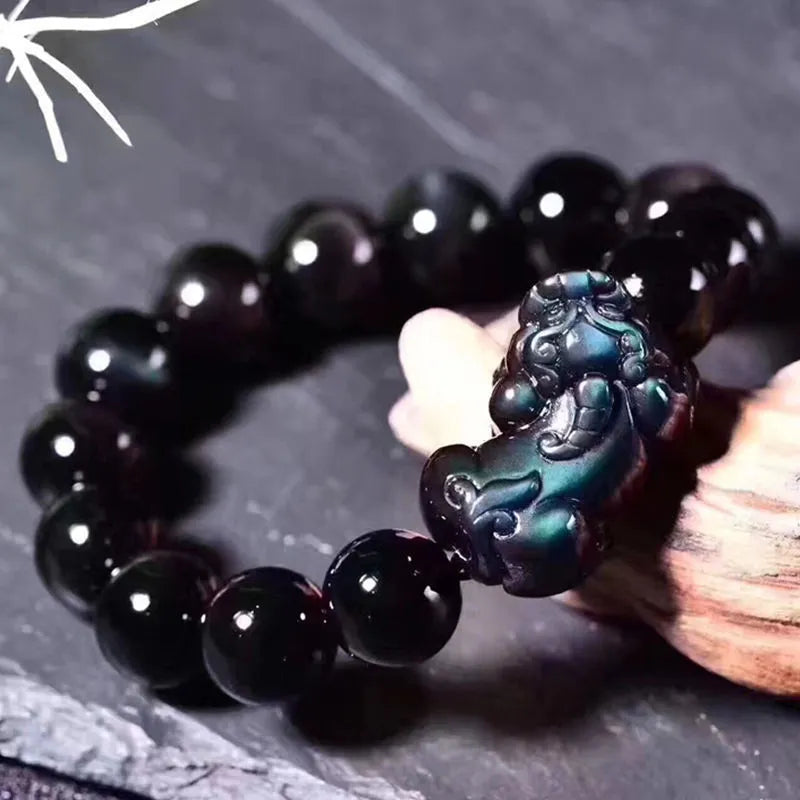 Natural Ice Colour Eye Obsidian crystal bracelet with round beads on an adjustable cord.