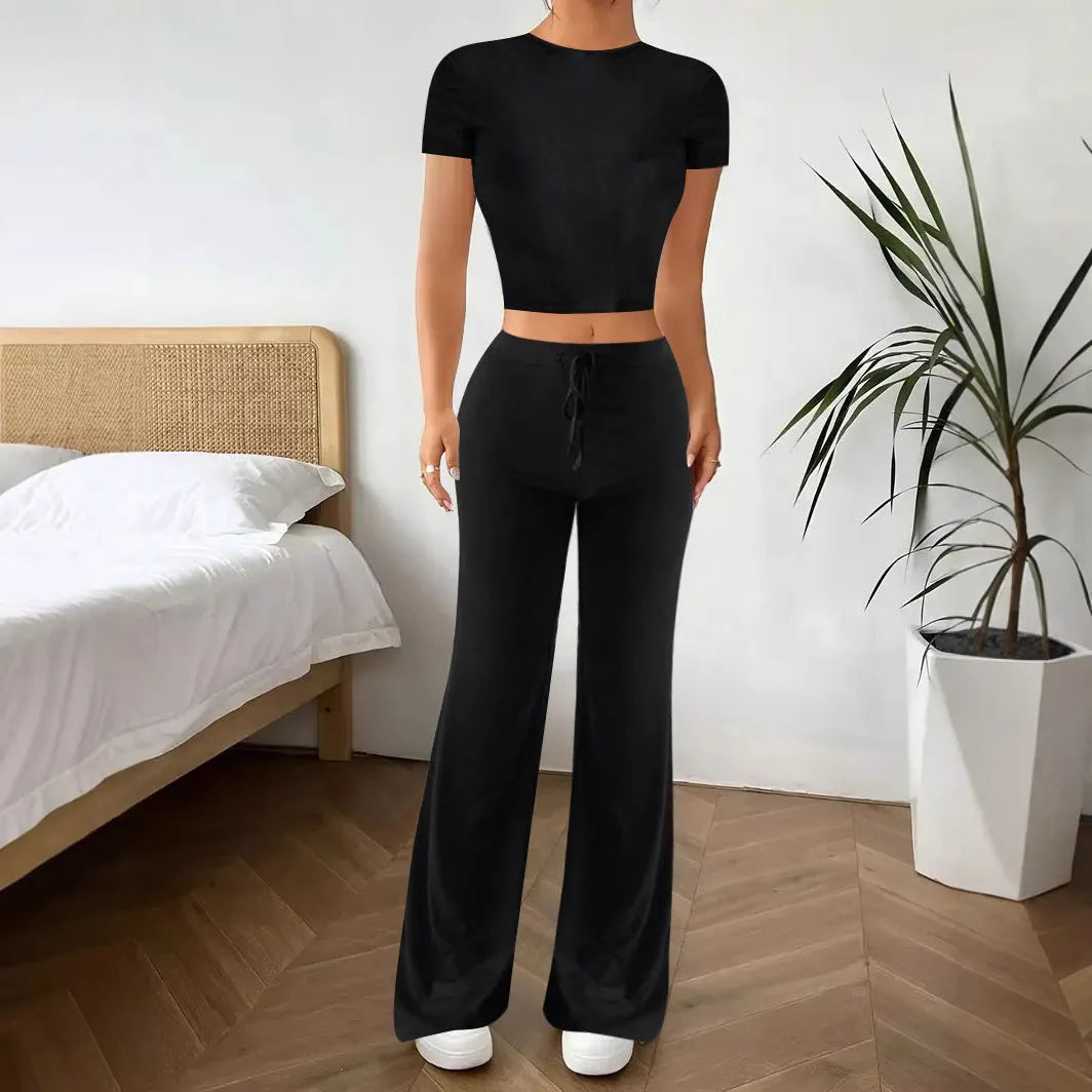 Black high-waist trousers and regular-sleeve T-shirt matching set for women laid flat.