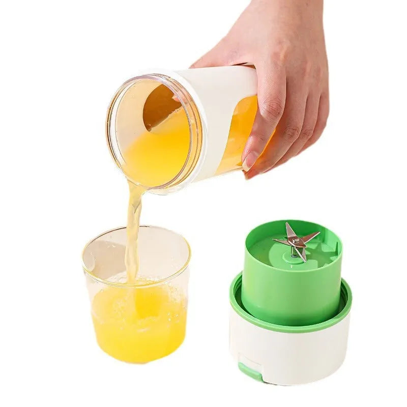 Portable electric juicer with USB charging cable next to 400ml plastic blending cup