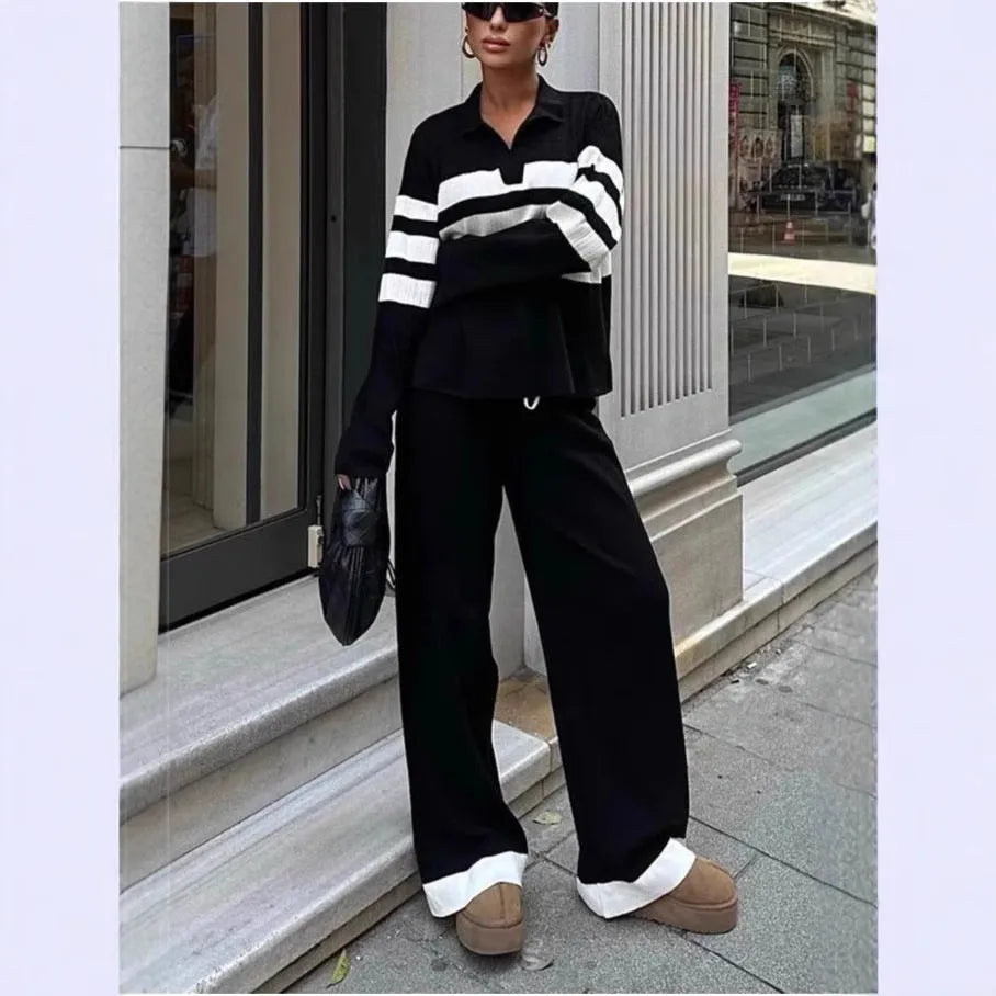 Women's black and white striped knitted top with polo collar and matching trousers casual set.
