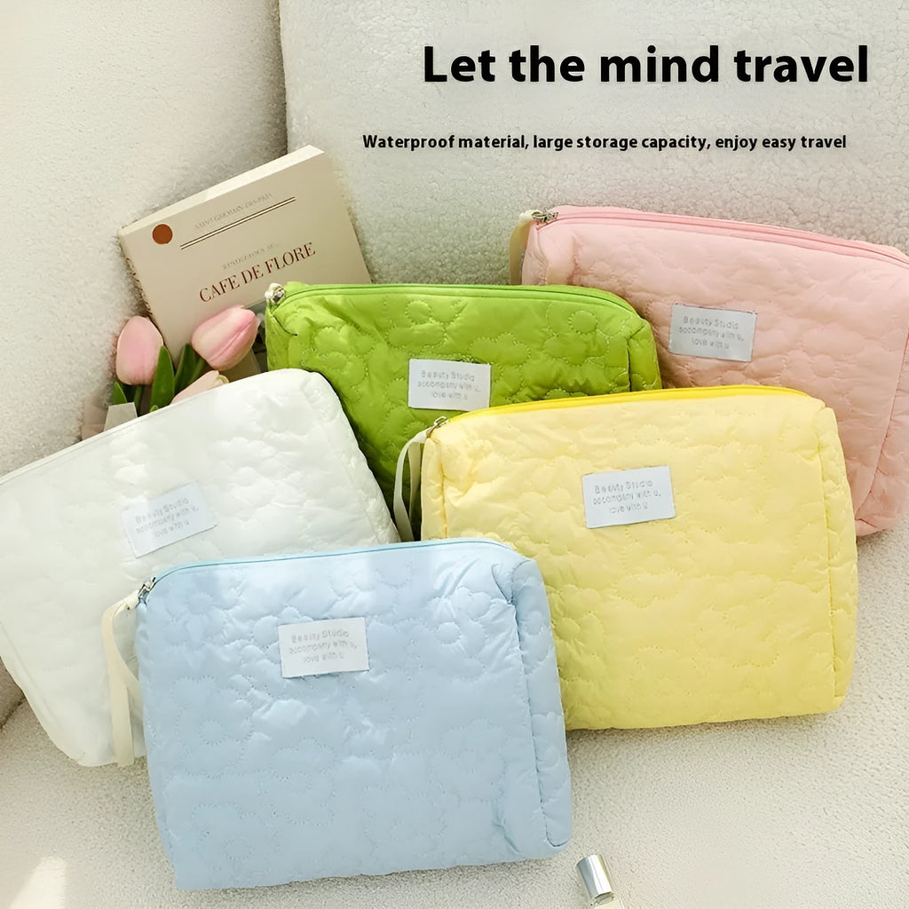 Quilted silk cosmetic storage bag in candy pink, yellow, blue, white, and green colours showing medium and large sizes.