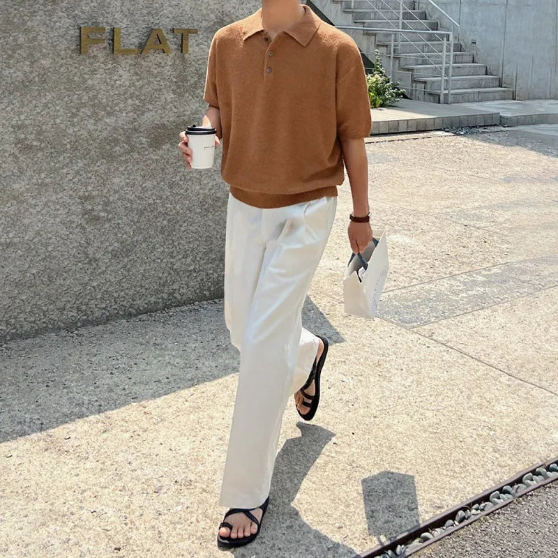 Men's caramel coloured loose fit knitted polo shirt with short sleeves and an asymmetrical design detail.