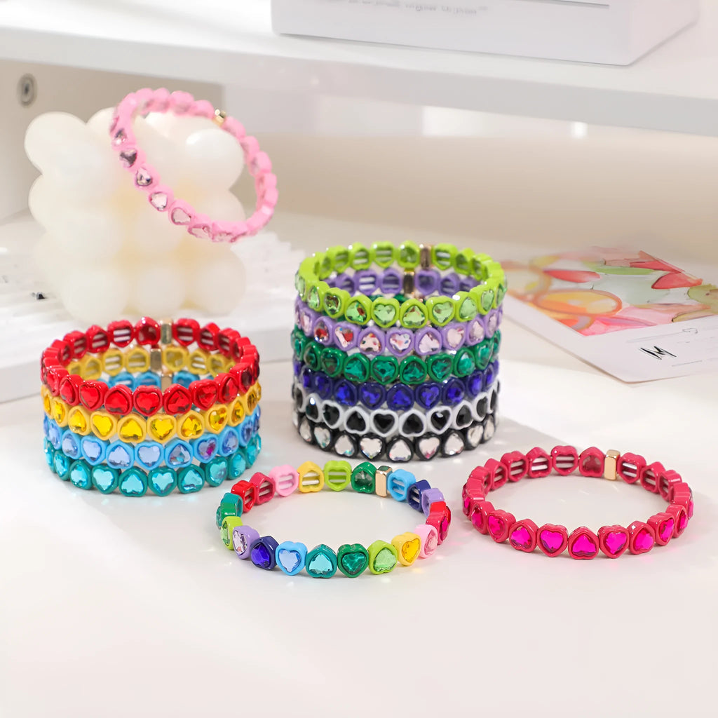 Rainbow coloured alloy heart charms on a stretchy elastic bracelet.