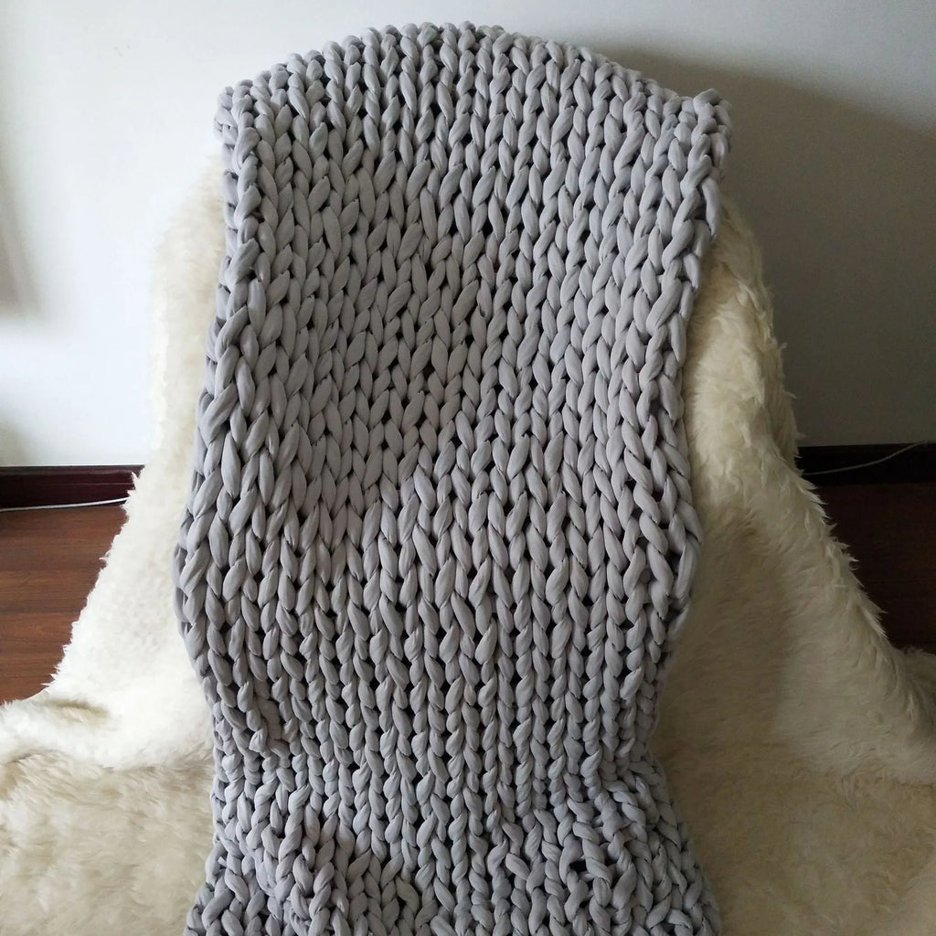 Hand-woven chenille polyester weighted blanket in beige solid colour, 200x200cm size on a bed.