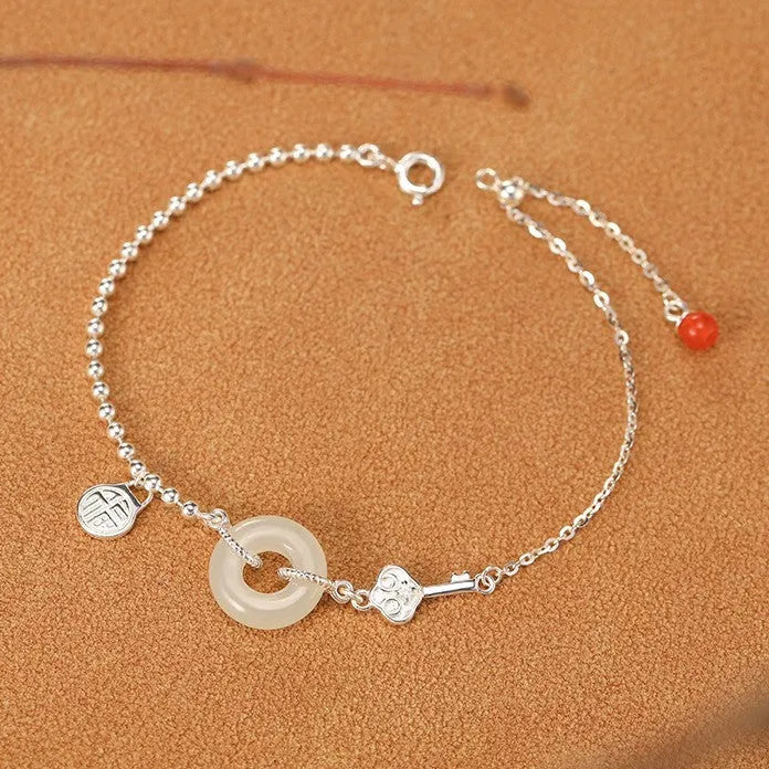 Silver bracelet with geometric peace buckle charm containing Hetian jade, traditional Chinese women's jewellery
