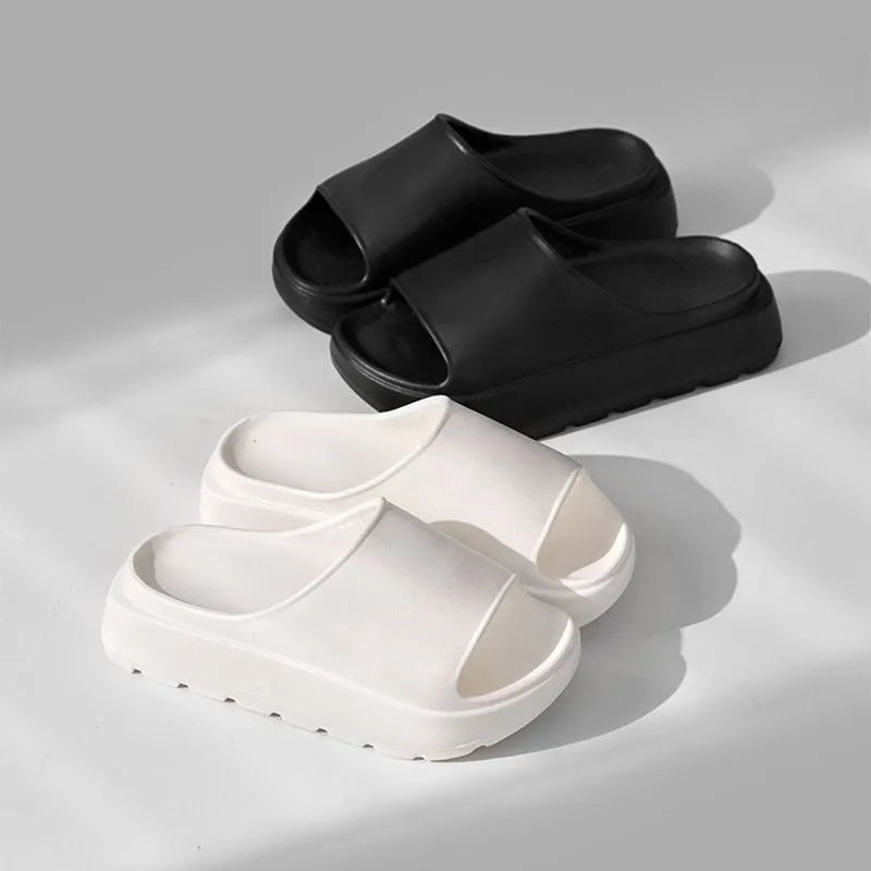 Women's beige fish mouth slippers with a thick 5.5cm EVA sole on a sandy beach.
