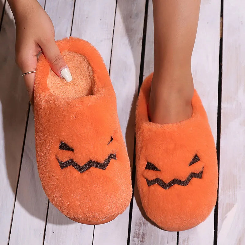 Orange Halloween pumpkin-themed plush indoor slippers with a coral velvet upper and non-slip PVC sole.