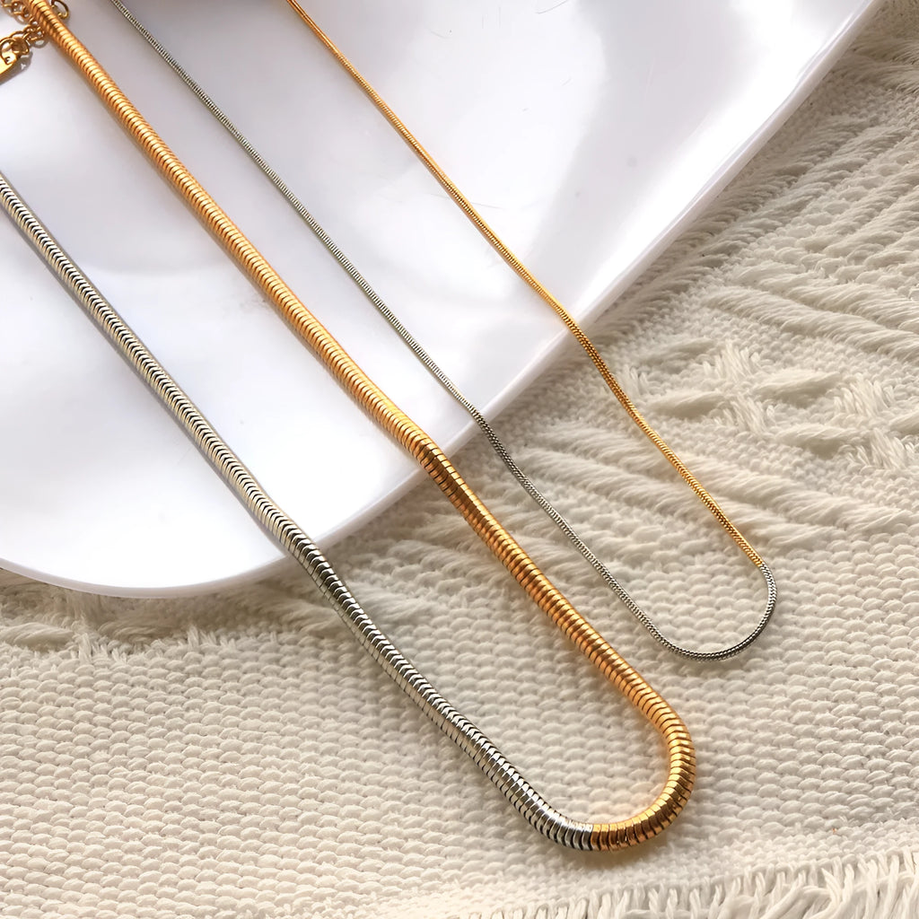 Women's cold golden 3mm wide stainless steel snake bones chain necklace, geometric design.