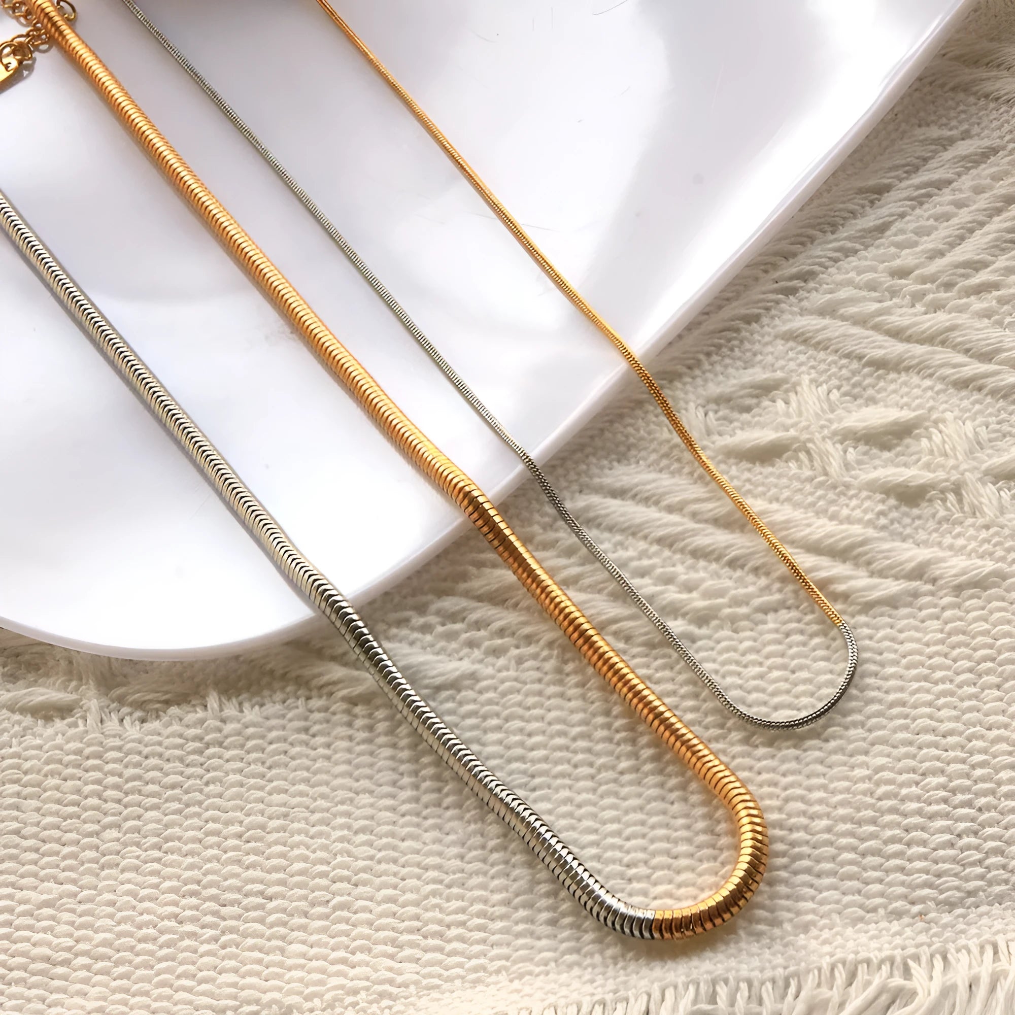 Women's cold golden 3mm wide stainless steel snake bones chain necklace, geometric design.
