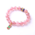 Pink strawberry quartz crystal bracelet with hand-woven construction and traditional Chinese ruyi lucky symbols