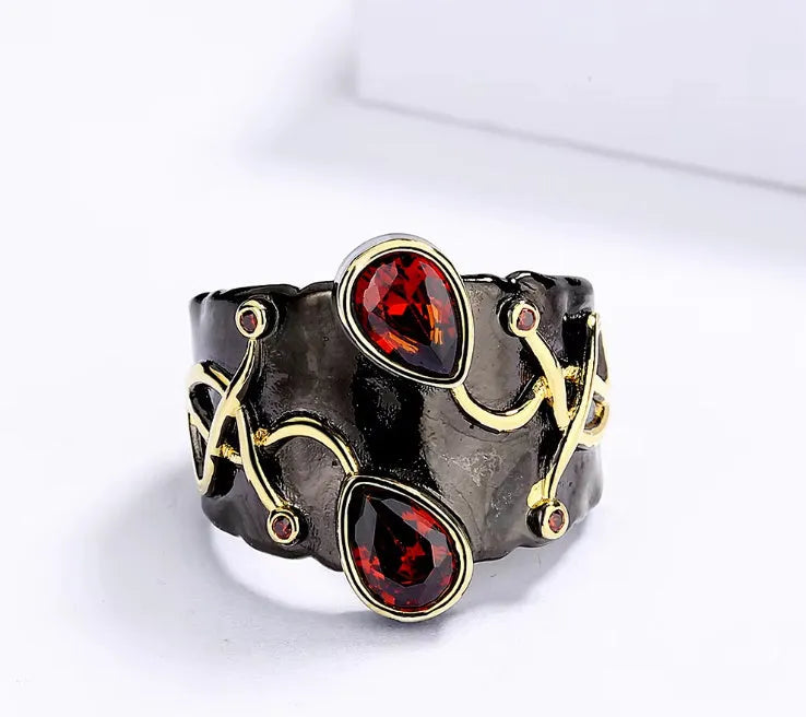 Retro women's straight-pull oval ring in brass with black finish, side view on light background