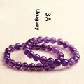 Scattered natural Uruguay amethyst beads for bracelet making in various sizes and purple shades.