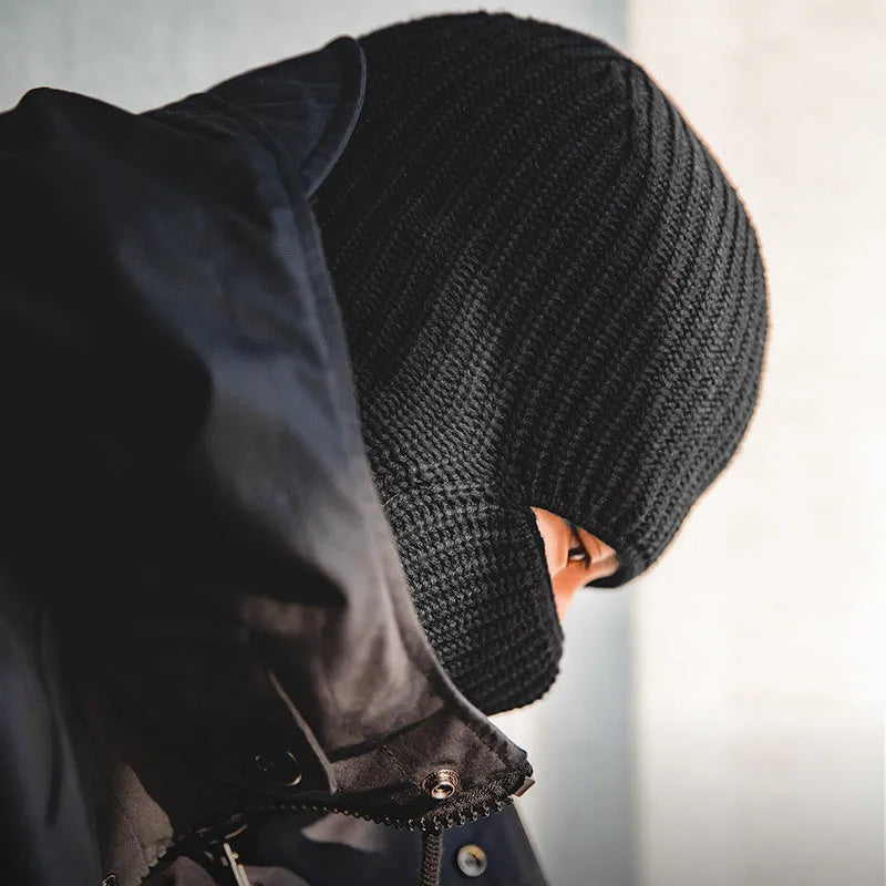 Vintage knitted melon skin warm beanie in black with patch detail on model wearing street-style outfit