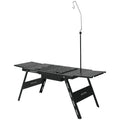 Folding multifunctional travel barbecue table with black steel construction and integrated cooking surface
