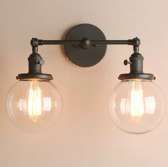 Double headed industrial wall lamp with spherical glass shades, iron black finish, 15x12x24cm