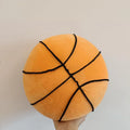 Soft spherical basketball plush toy in orange with black lines, 28cm tall, on a light background