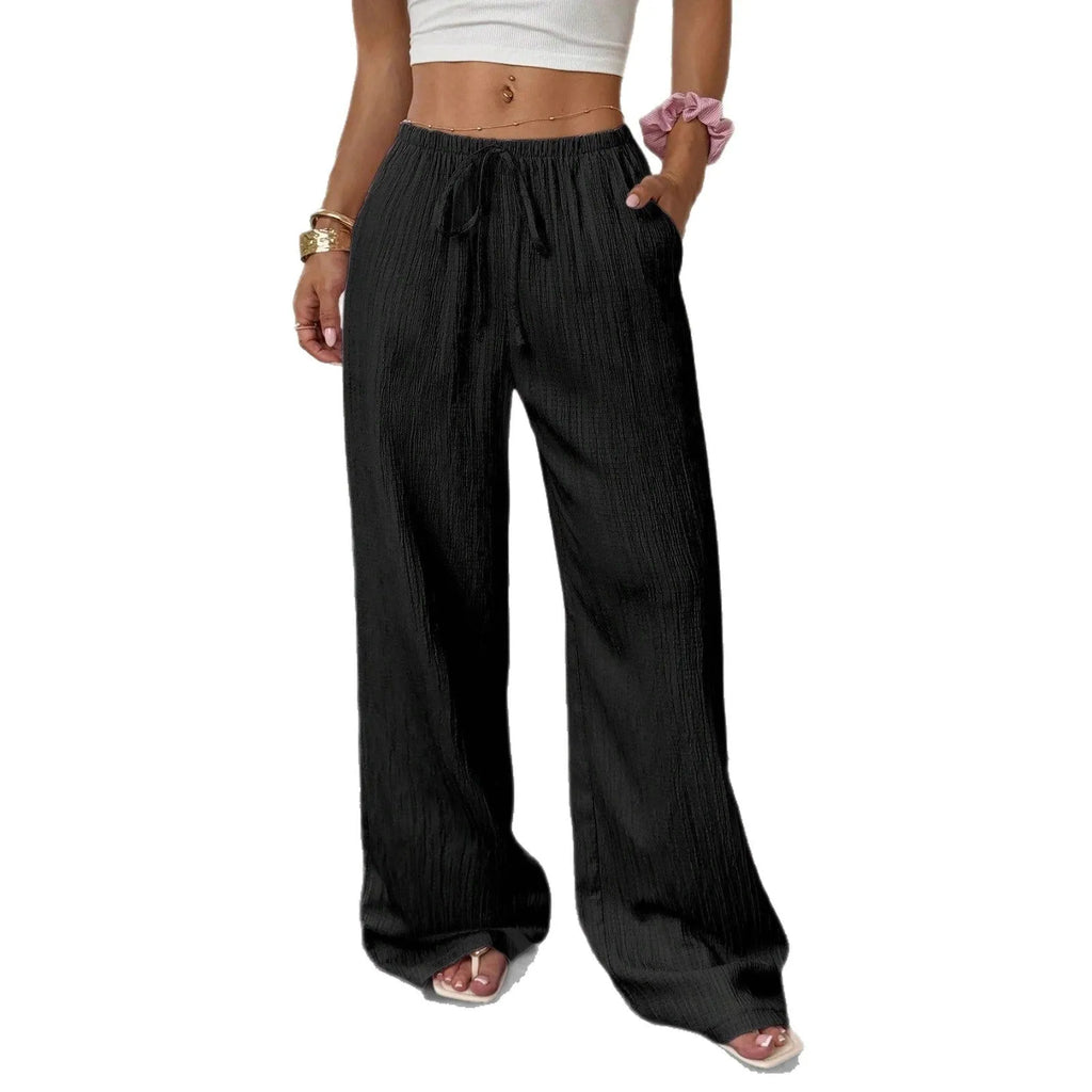 Women's wide-leg black trousers with a lace-up detail on the mid-rise waist