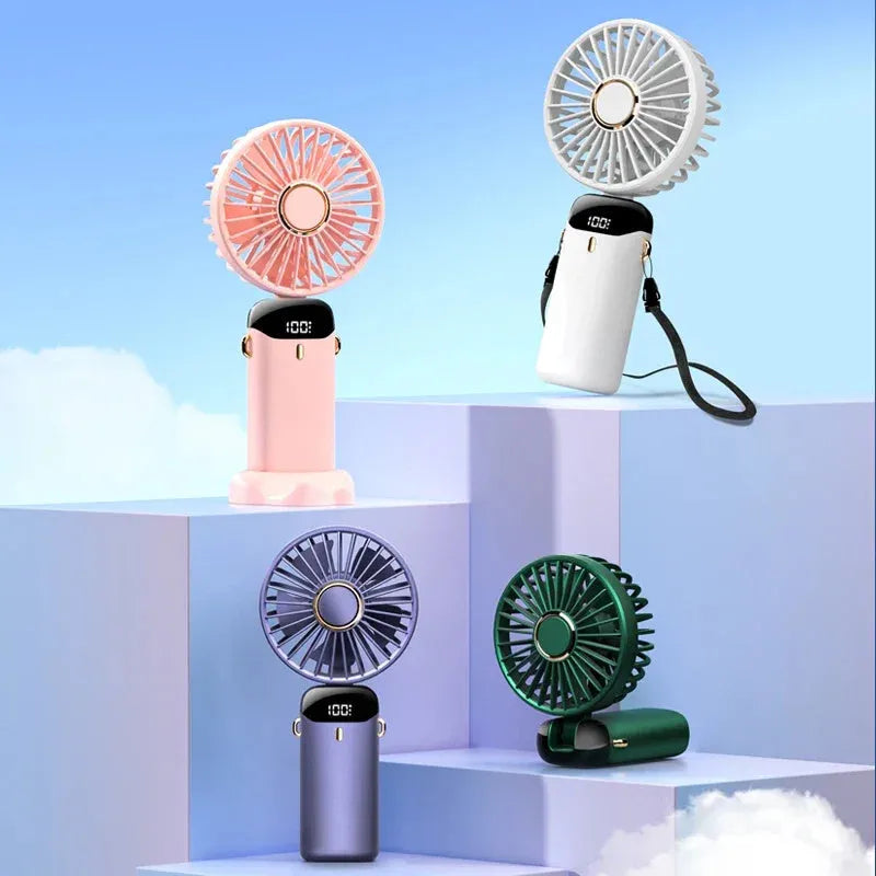 Blue portable USB rechargeable fan shown in handheld mode, with folding neck strap and digital battery display