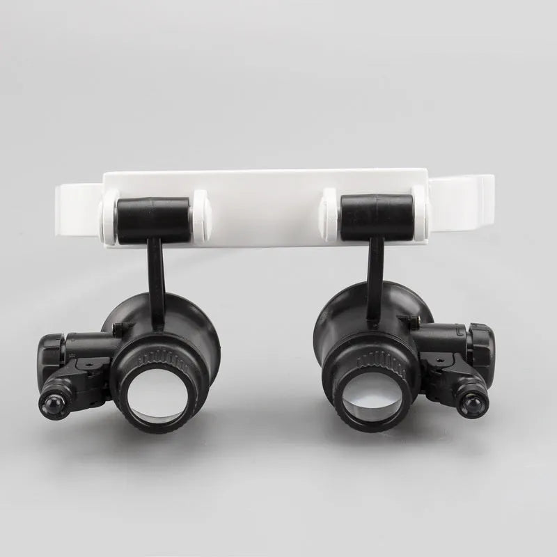 White head mounted magnifying glass with LED light, shown folded and unfolded for clock repair work.