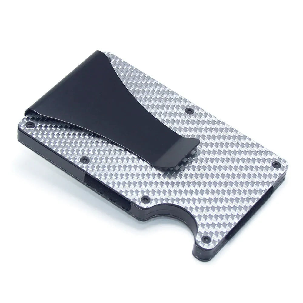 Slim black carbon fibre card holder wallet with geometric design on a desk.