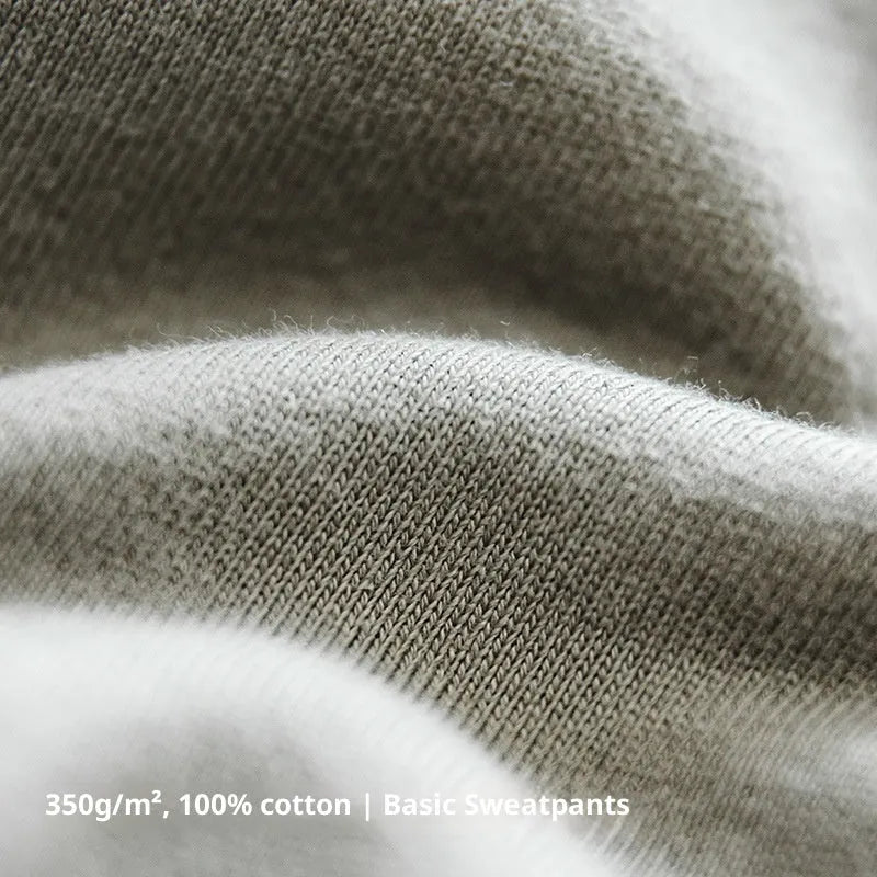 Men's cotton knitted sweatpants in olive green with tapered 3D cut hemming, straight leg retro style